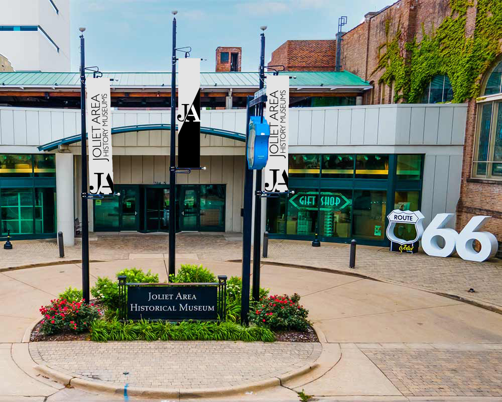 Front JAHM building with 3 JAHM logo flags