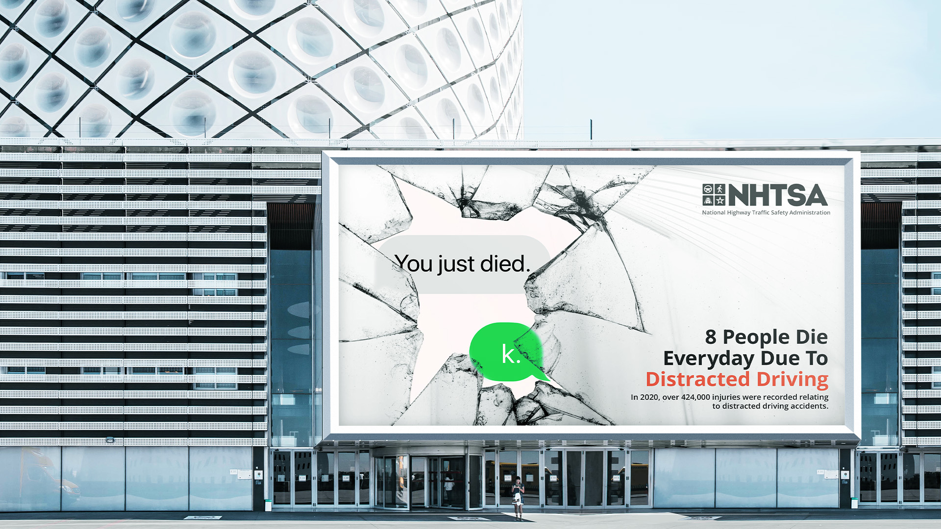 Modern Building with a large distracted driving psa advertisment on front